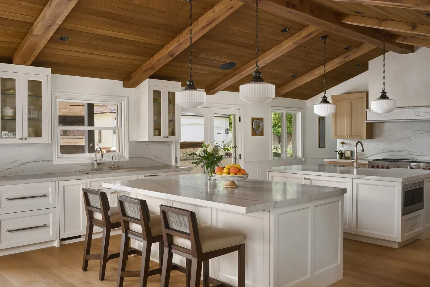 This side countertop, with cabinetry and sink feature, as well as beautiful french doors leading to a jaw dropping out door kitchen make cooking and entertaining a pleasure. 