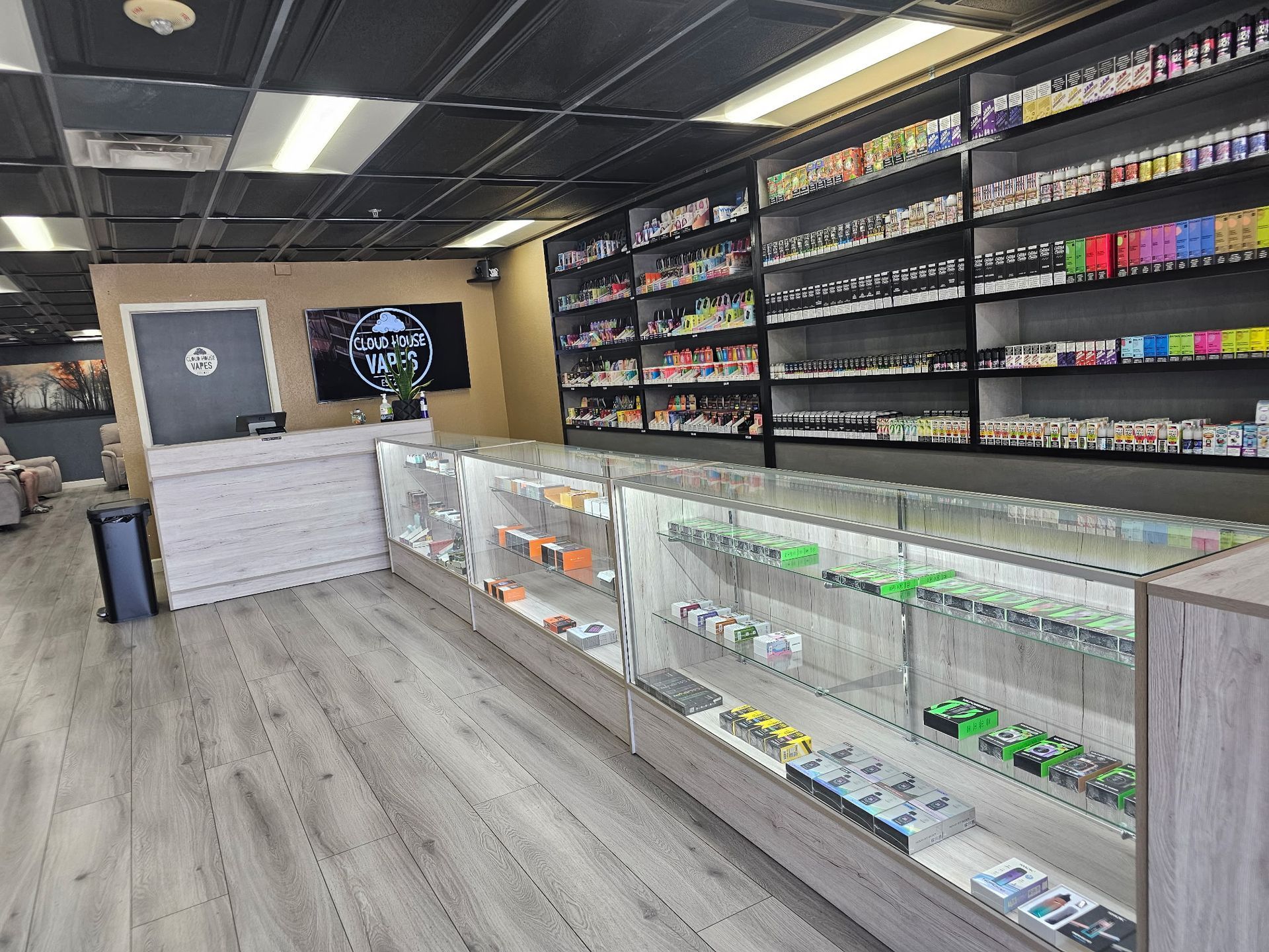 A store filled with lots of e-cigarettes and a counter.