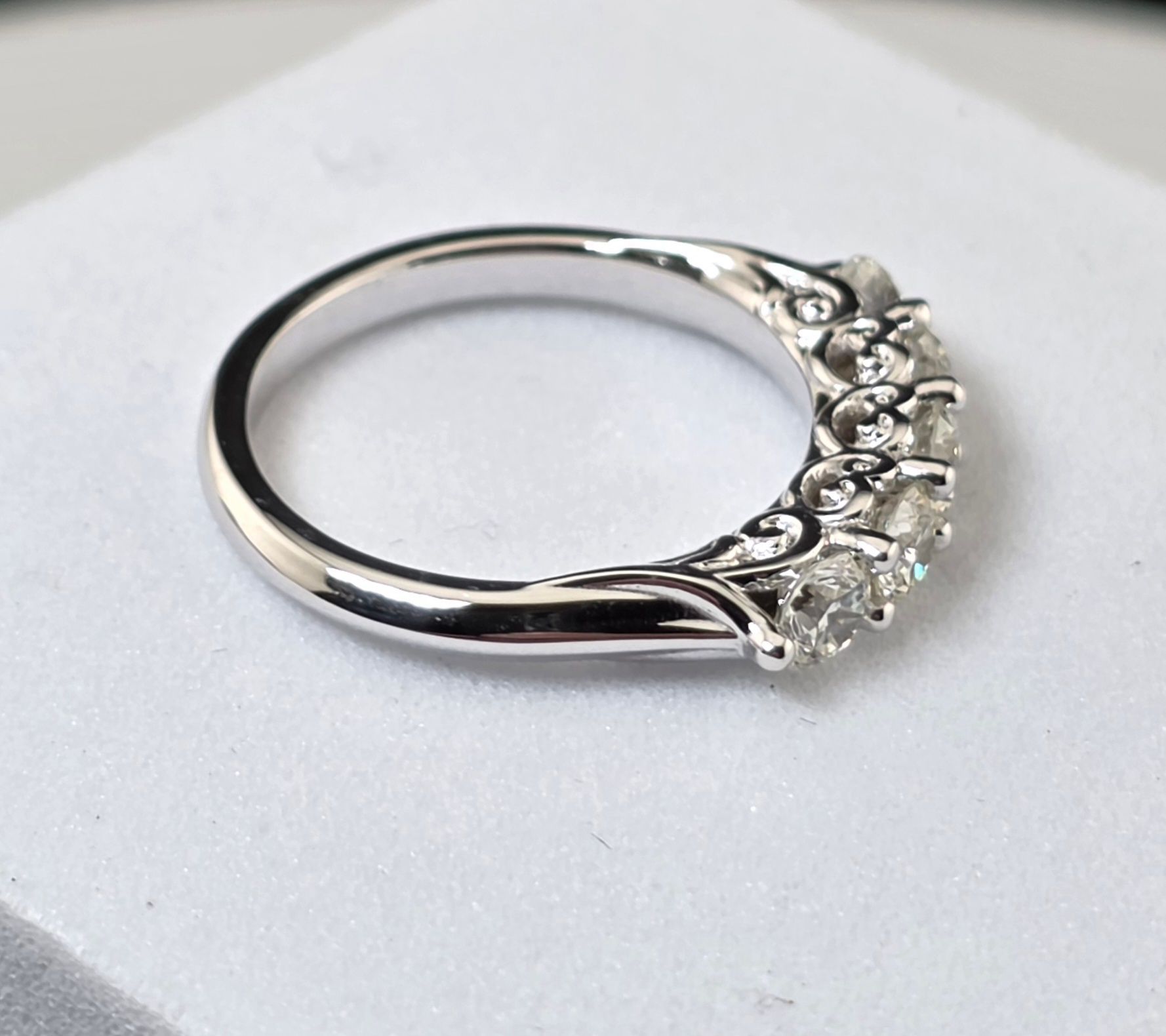 Silver ring with diamonds on a white background