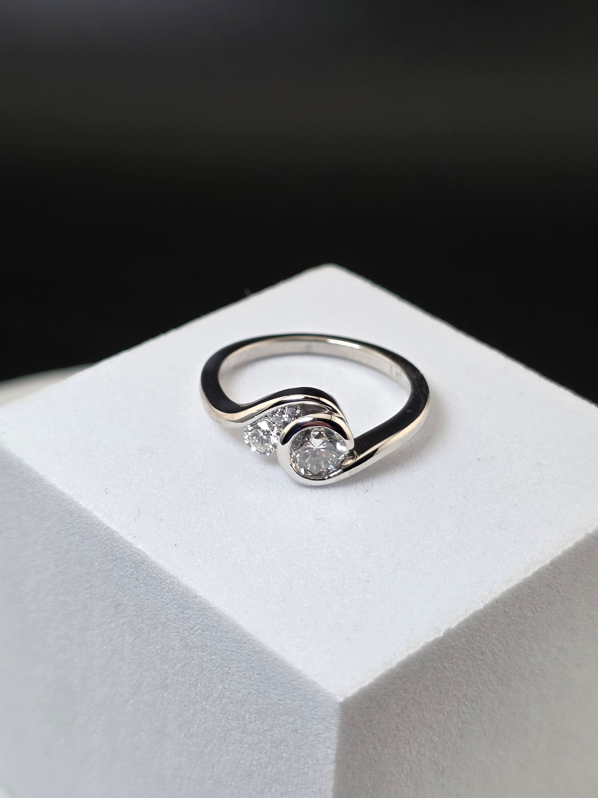 Silver ring with a diamonds on a white display stand