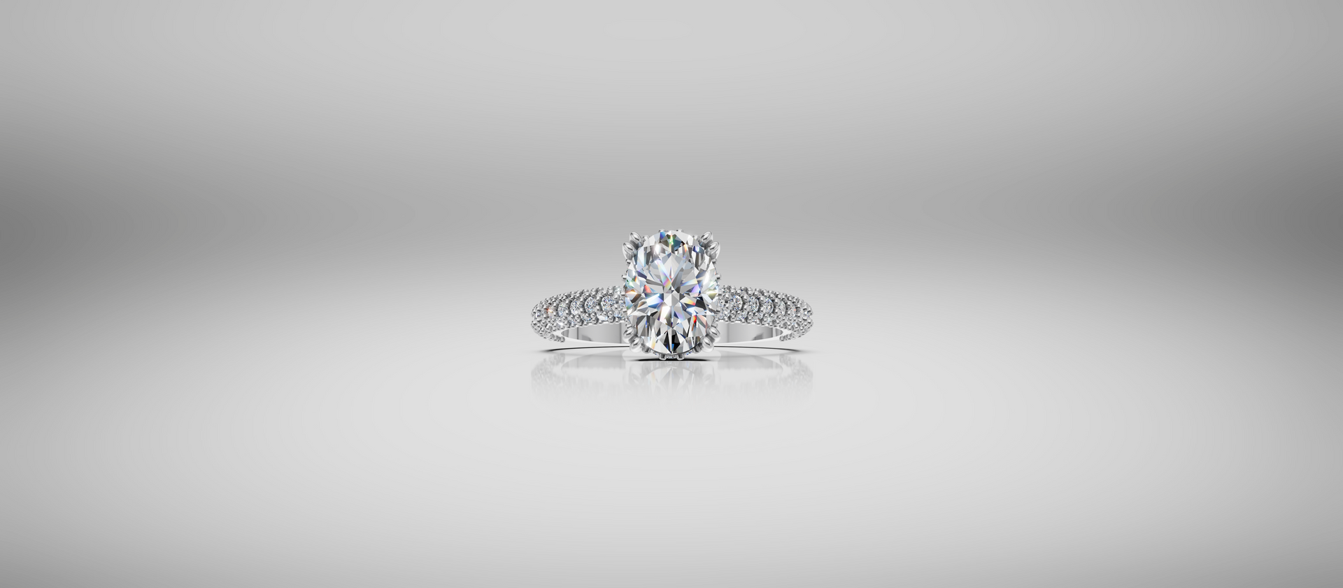 Diamond ring on a soft gray background, centered and sparkling.