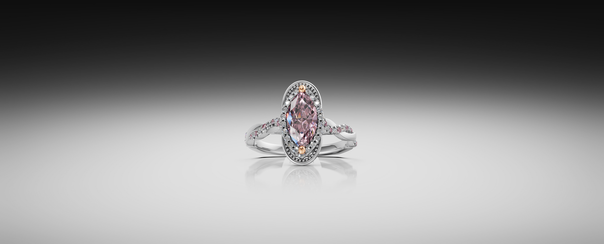 Pink gemstone ring on a white surface with a soft gray background