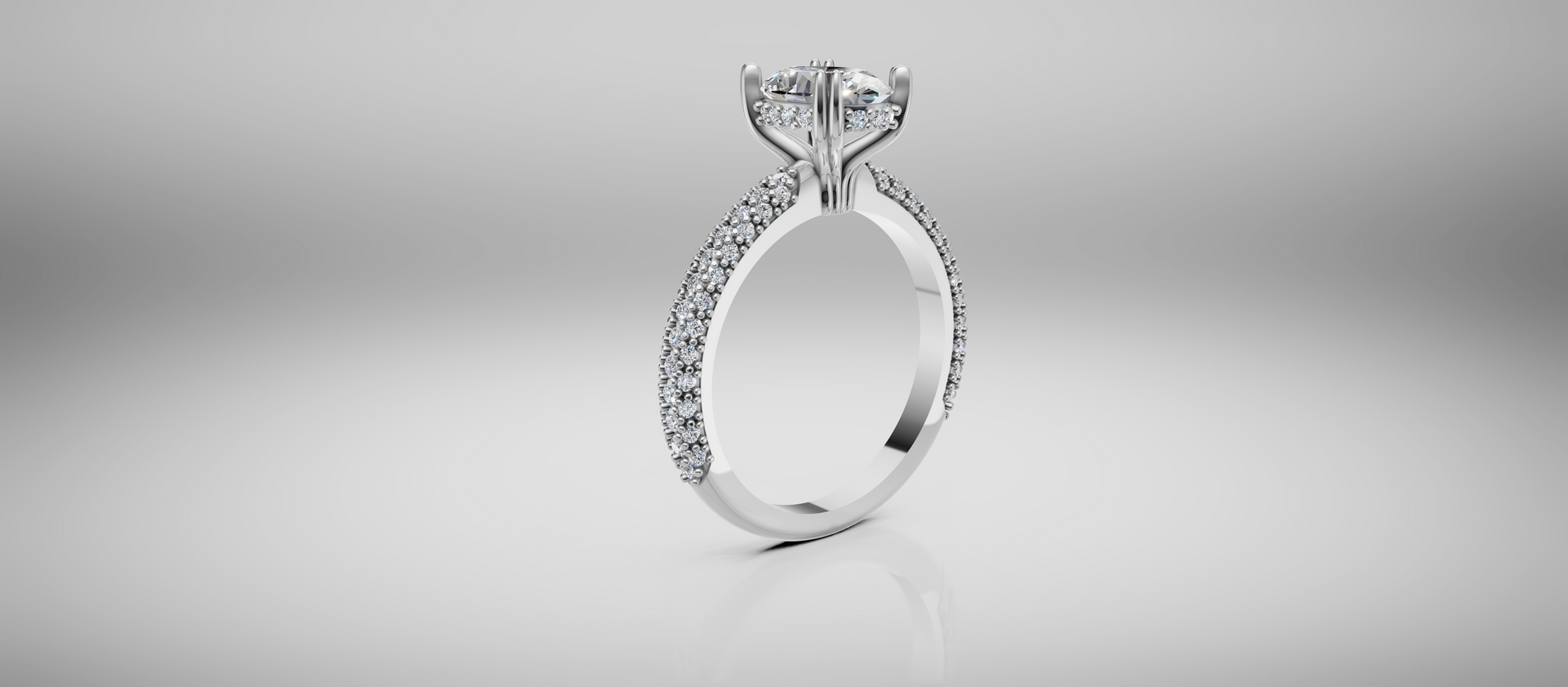 Diamond engagement ring on a white reflective background