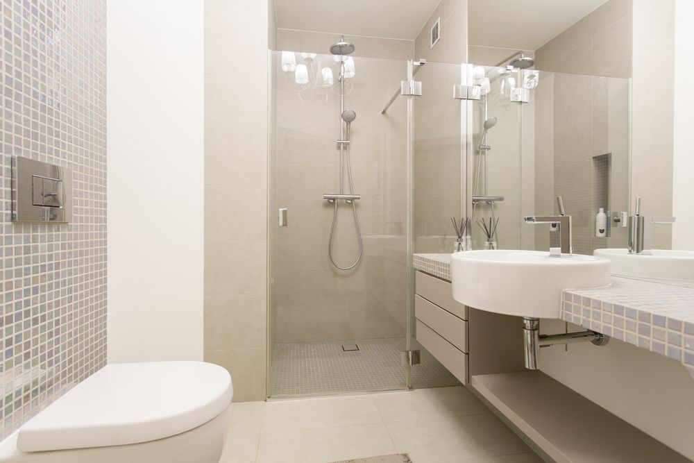 A Bathroom With A Toilet, Sink, Shower And Mirror — All About Glass Lake Macquarie In Cessnock, NSW