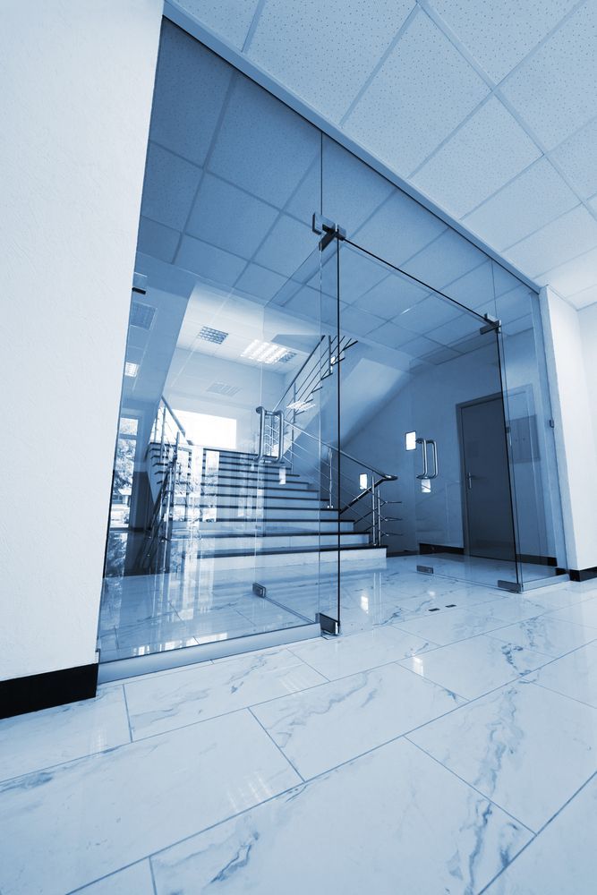 A Hallway With A Glass Door And Stairs In A Building — All About Glass Lake Macquarie In Ellalong, NSW