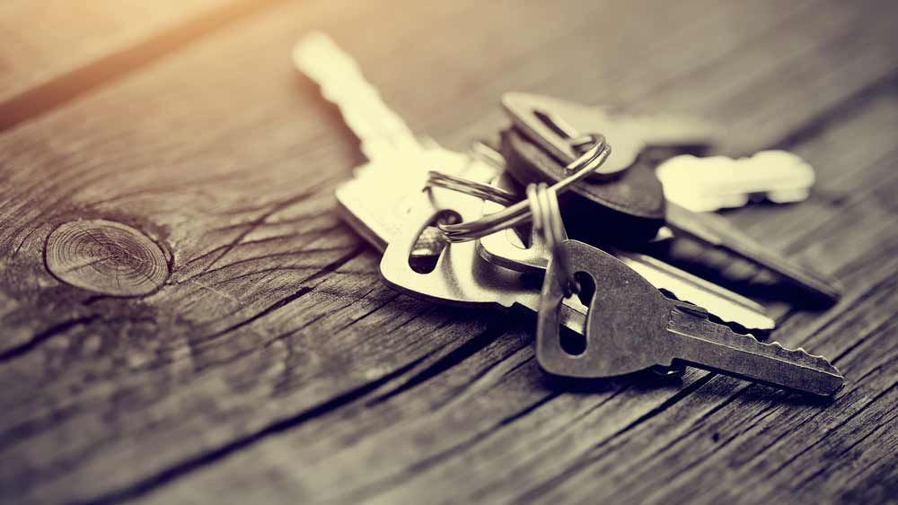 Multiple Keys On A Wooden Table — Coast 2 Coast Locksmiths in Buderim, QLD