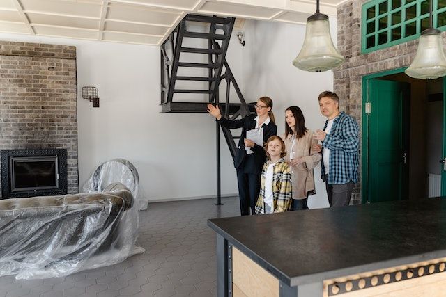A property manager walking through a unit with a family of three