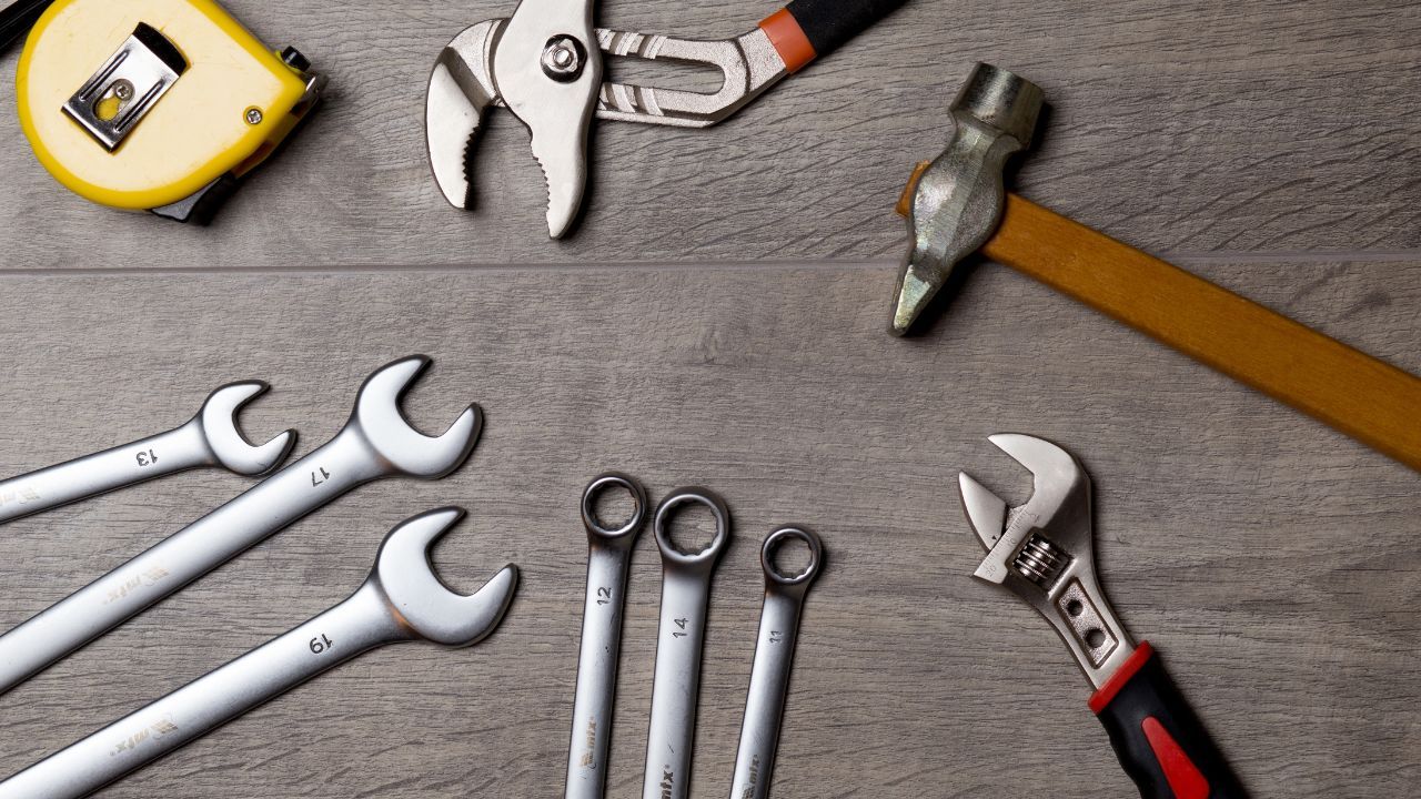 An assortment of tools on a wooden table