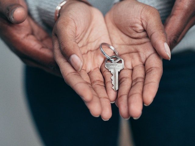 A key in the middle of a person's palms