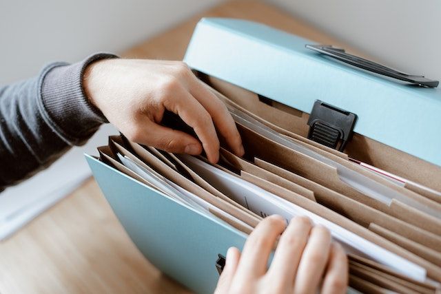 person choosing a document in a folder