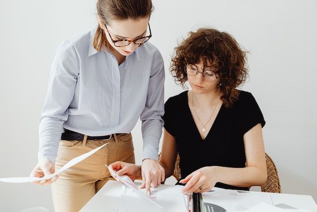 Two people looking at a document together
