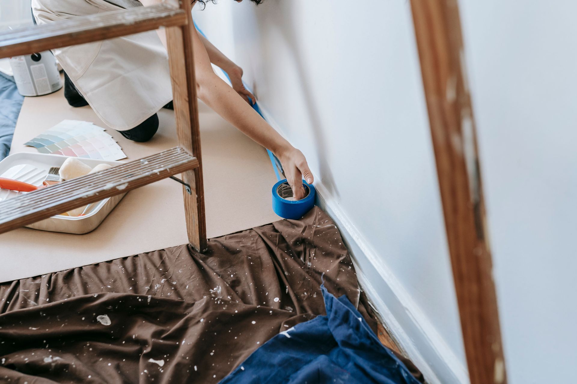 person preparing room for painting