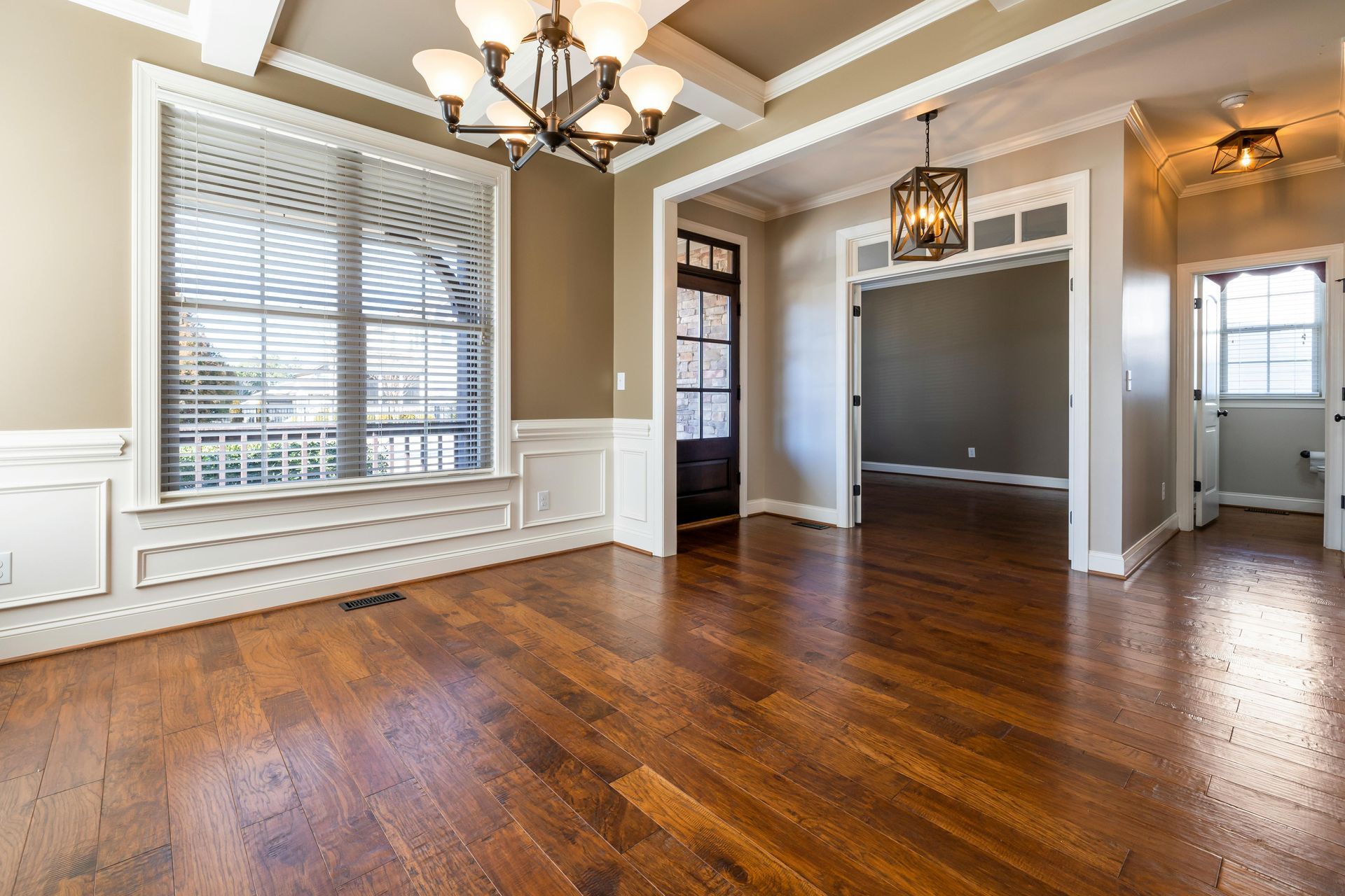 An Empty Living Room with Parquet Flooring