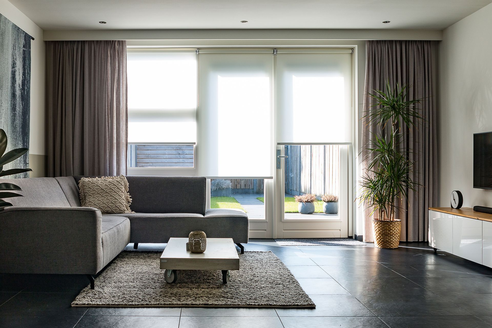 A modern living room with sleek furniture, natural light, and minimalist decor.