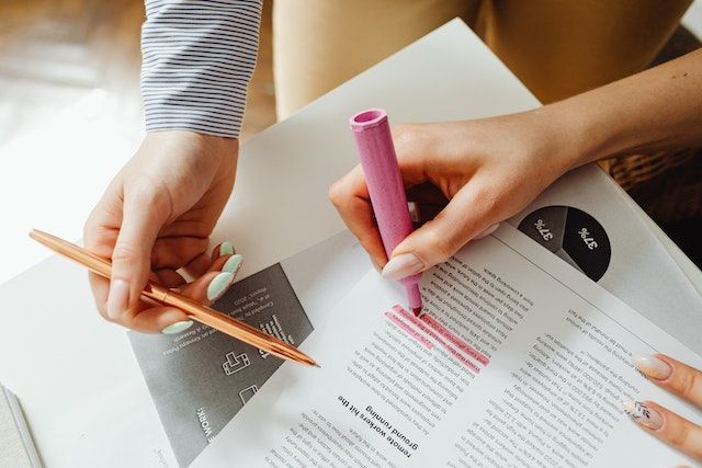 someone highlighting something from a piece of paper