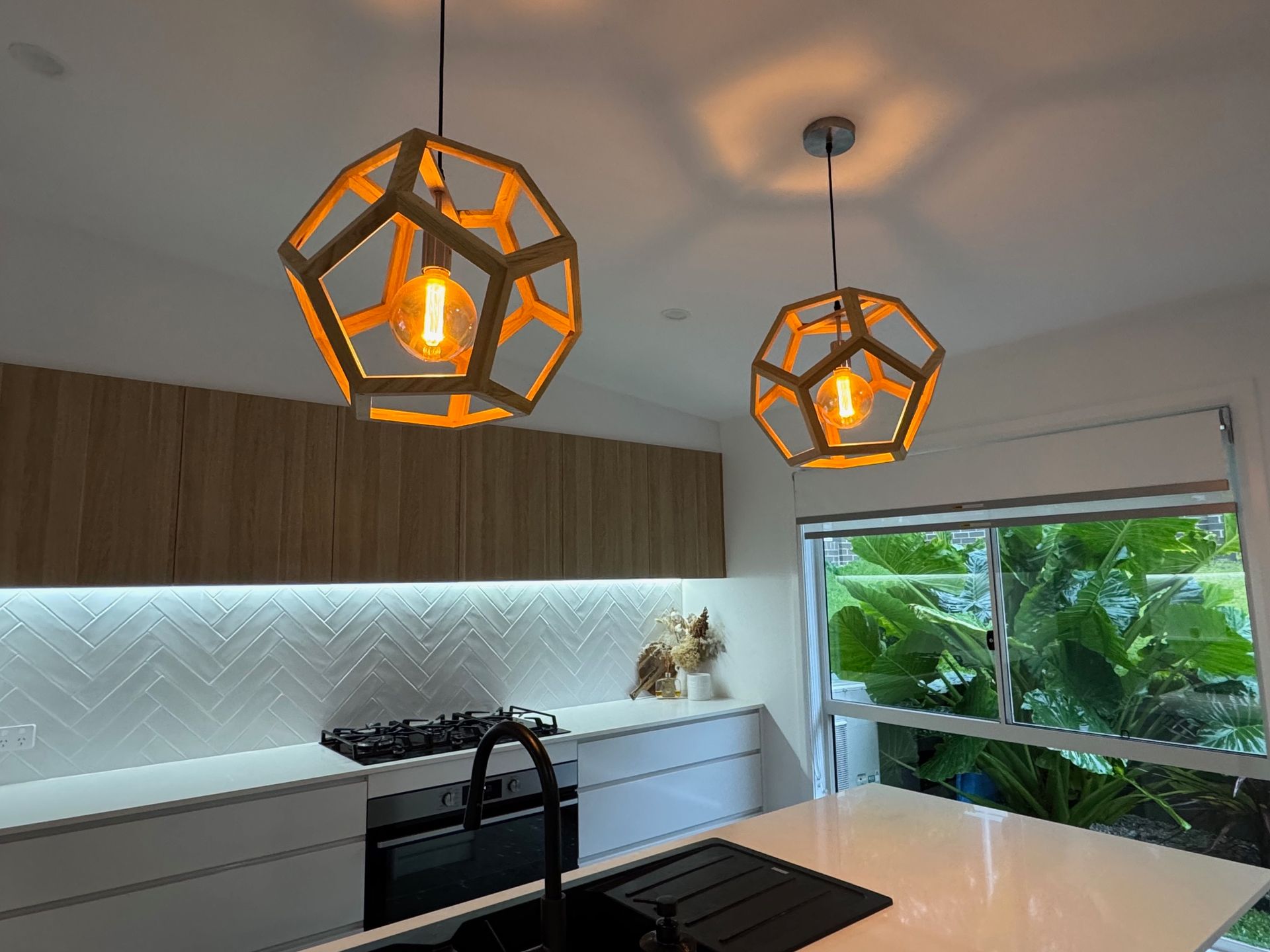 A Kitchen With a Large Island and Stools — Anderson Electrical & Air in Taree, NSW