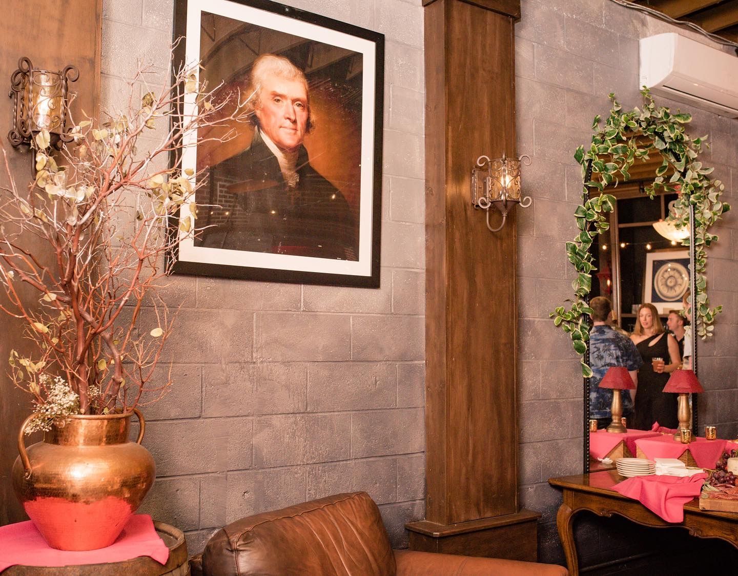 A living room with a picture of a man on the wall