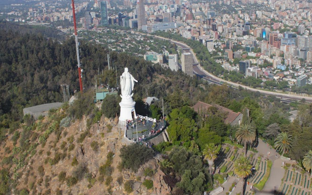Virgin Mary statue at the summit of Cerro San Cristóbal overlooking Santiago city skyline