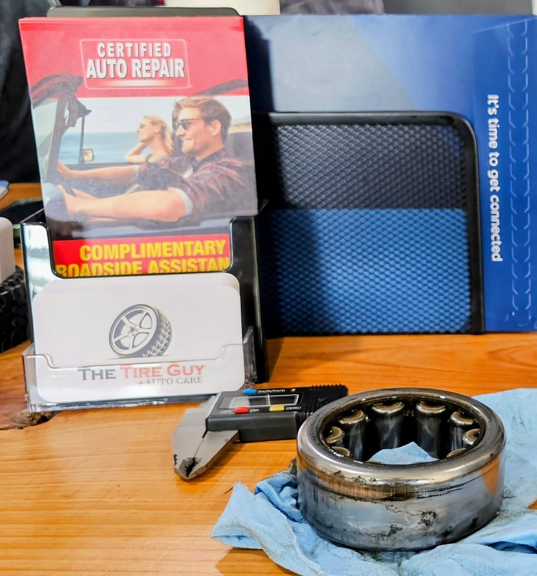 A certified auto repair pamphlet sits on a desk