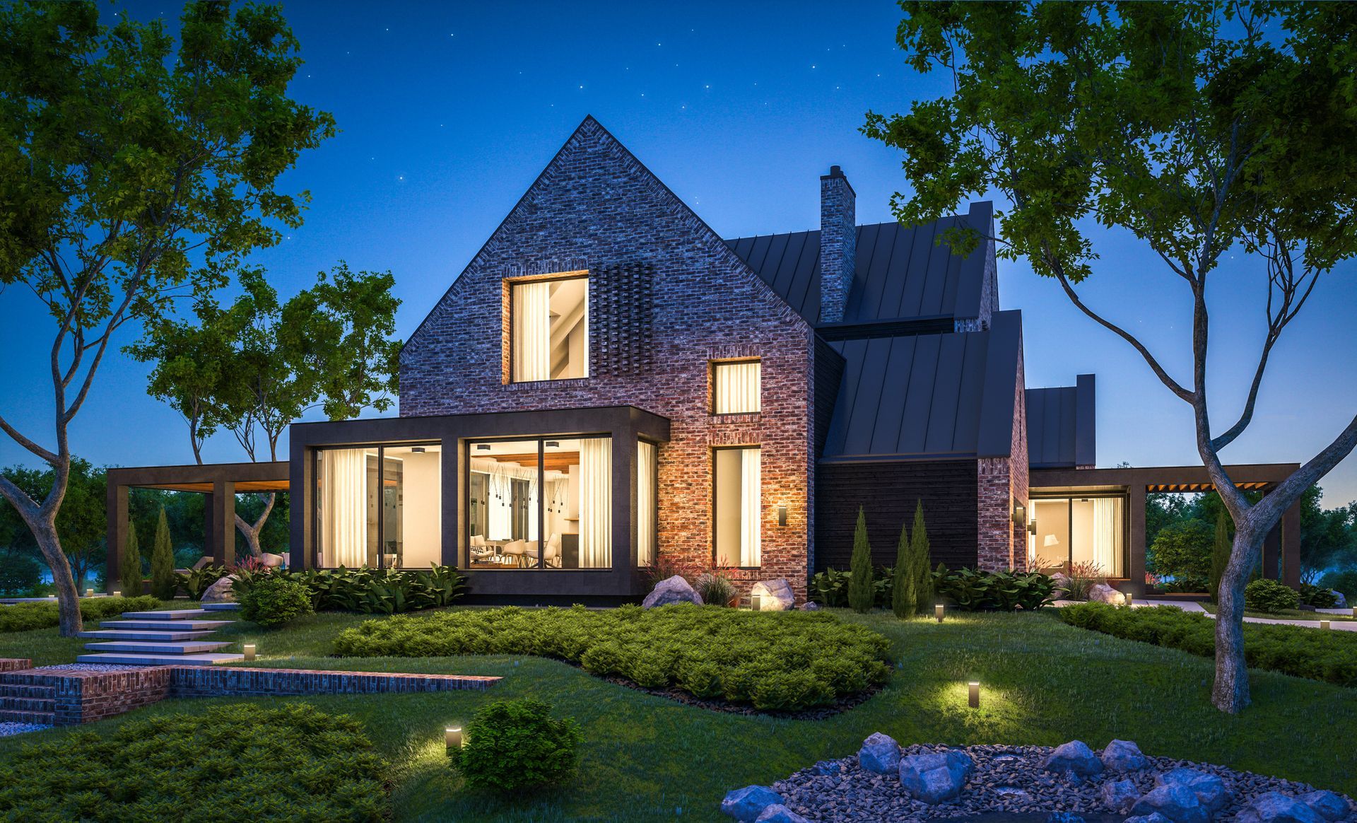 A large brick house with a lot of windows is lit up at night.