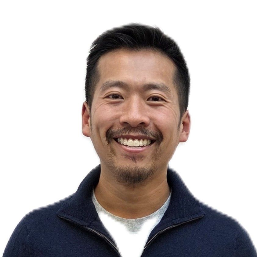 Smiling man in a navy sweater on a white background