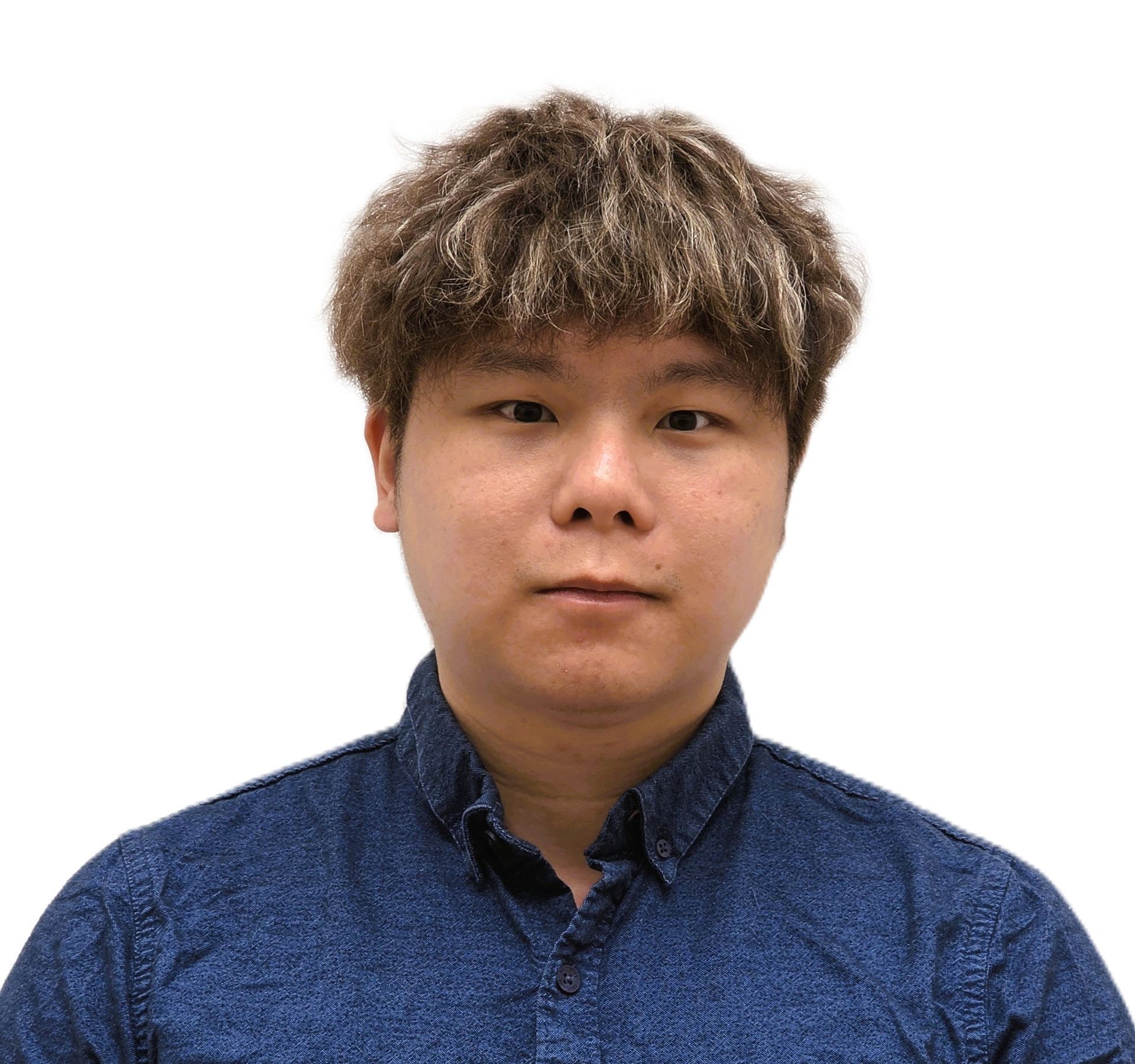 Studio portrait of a person with curly hair wearing a blue button-up shirt against a white background