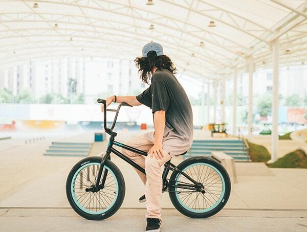 Man Riding His BMX Bike — Gladstone Bicycle Centre in Gladstone, QLD