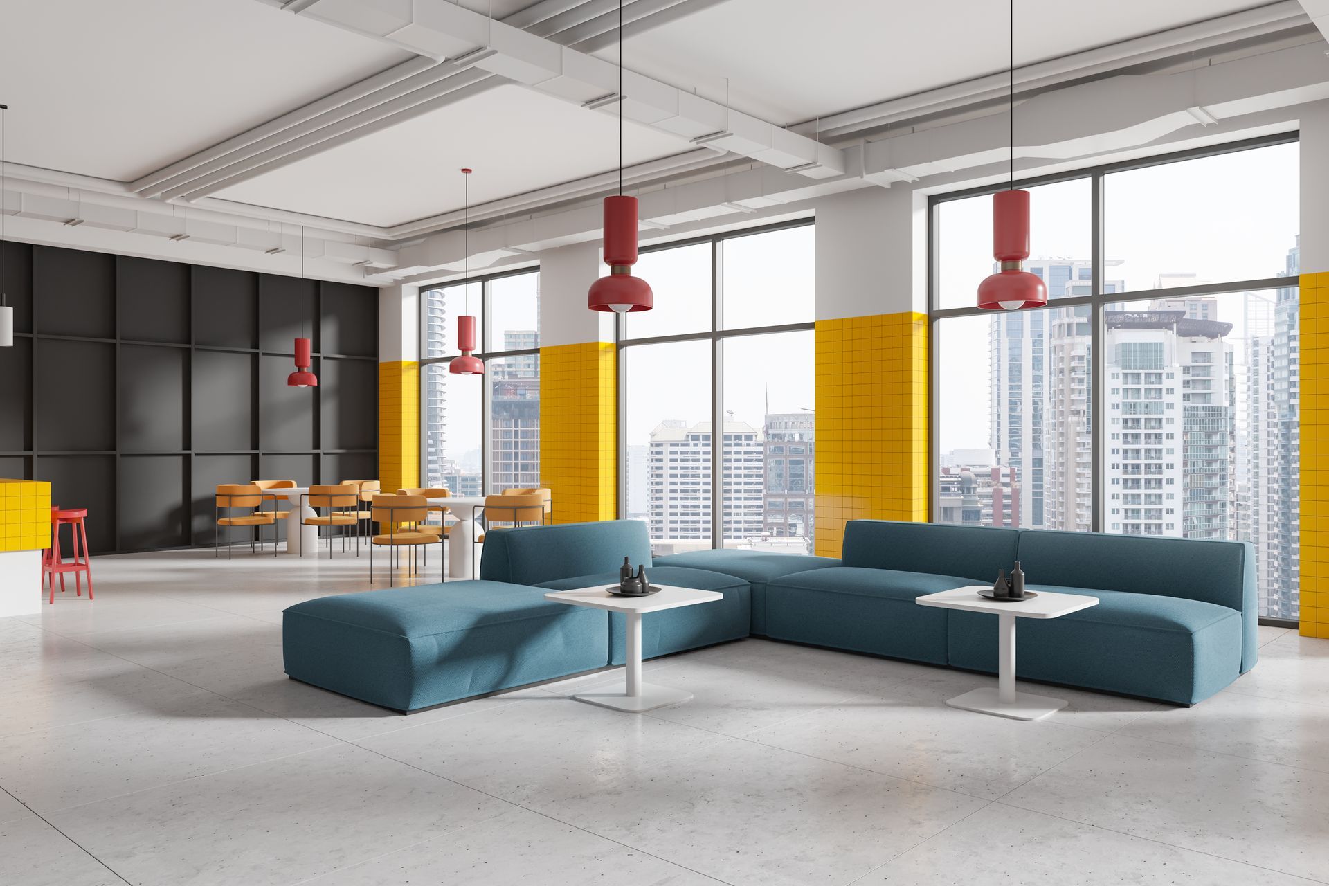 Modern open office lounge with teal sofas, red pendant lights, and city-view windows