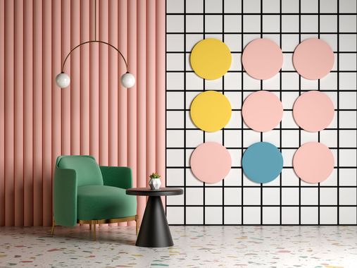 Modern lounge with green chair, pink wall, black table, and colorful circle wall art