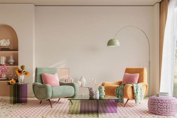 Pastel living room with two chairs, floor lamp, flowers, and patterned rug