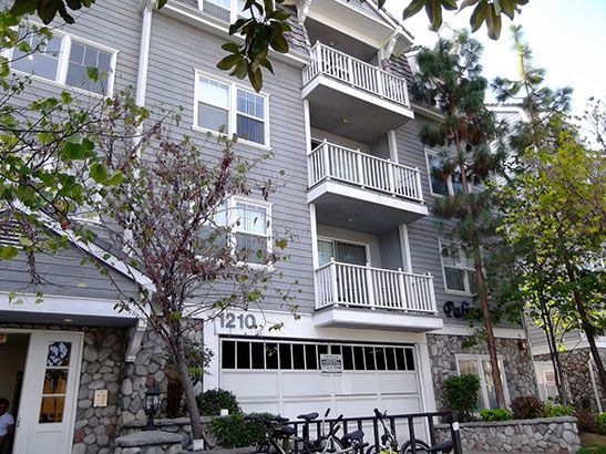 A large apartment building with a garage and balconies.