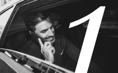 Man smiling while talking on a phone from a car window, with a large number 1 overlay.