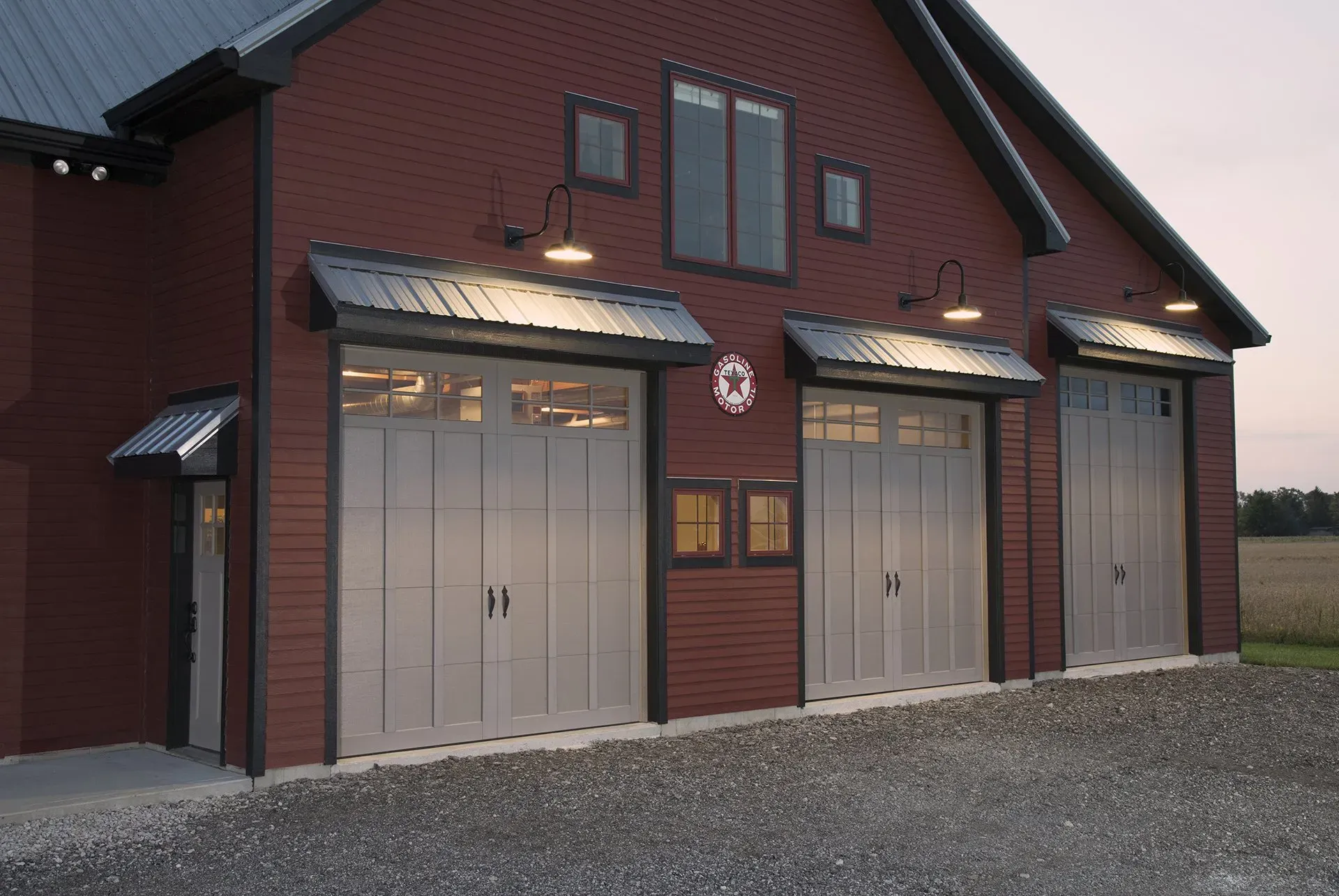 Red brick garage with three gray garage doors.Large Garage Door Commercial