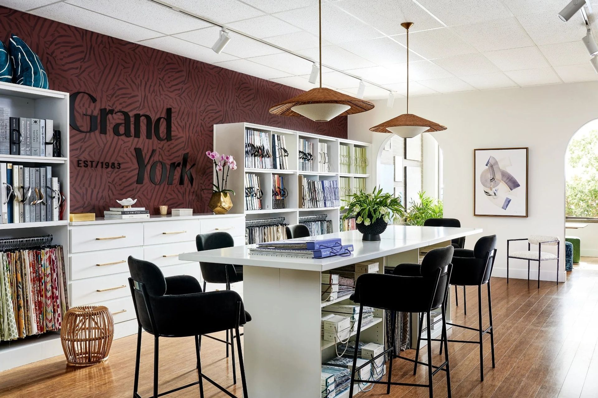 Interior of Grand York design studio with fabric samples, seating, and lighting fixtures.