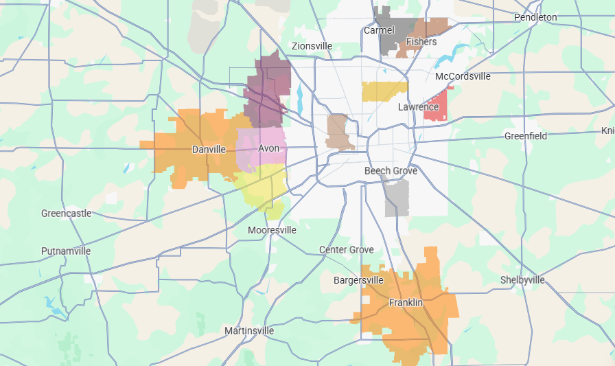 City map with colored highlighted areas in orange, yellow, and pink around a central road network.