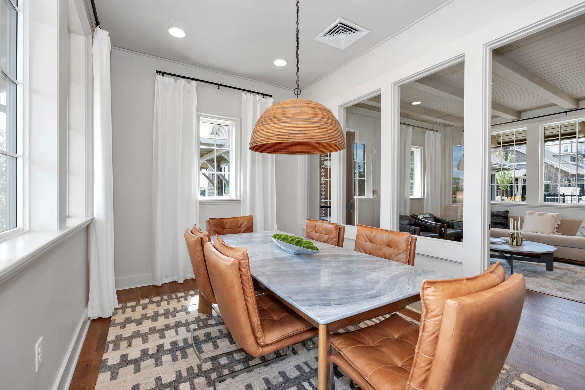 A living room with a lot of furniture and a painting on the wall.