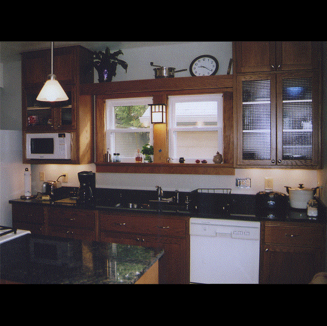 A kitchen with wooden cabinets and a white dishwasher
