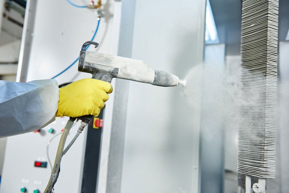 professional spraying chemical on metal