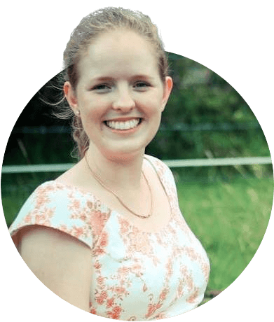 A woman in a floral dress is smiling in a circle.