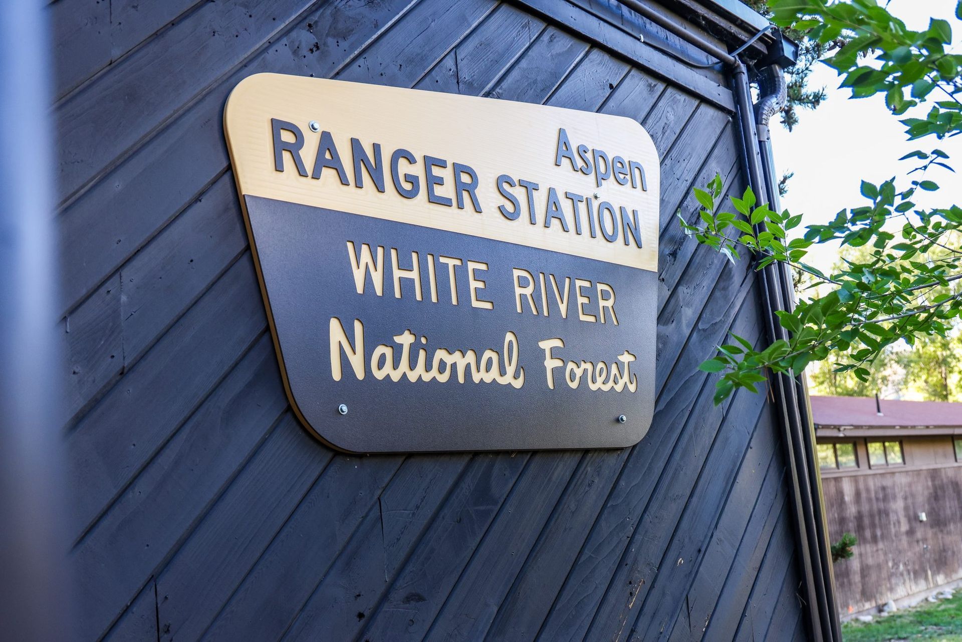 aspen ranger station sign outside of a building