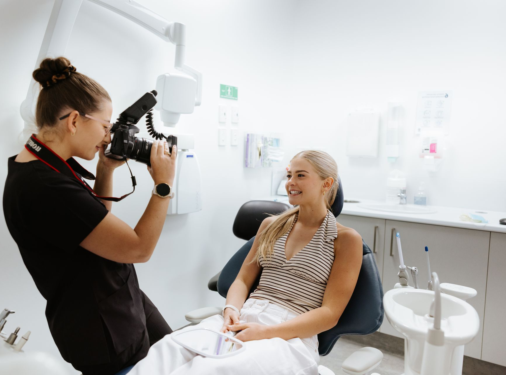 Woman in dental chair, photographer taking photo in office. — McDonald Dental in Gympie, QLD