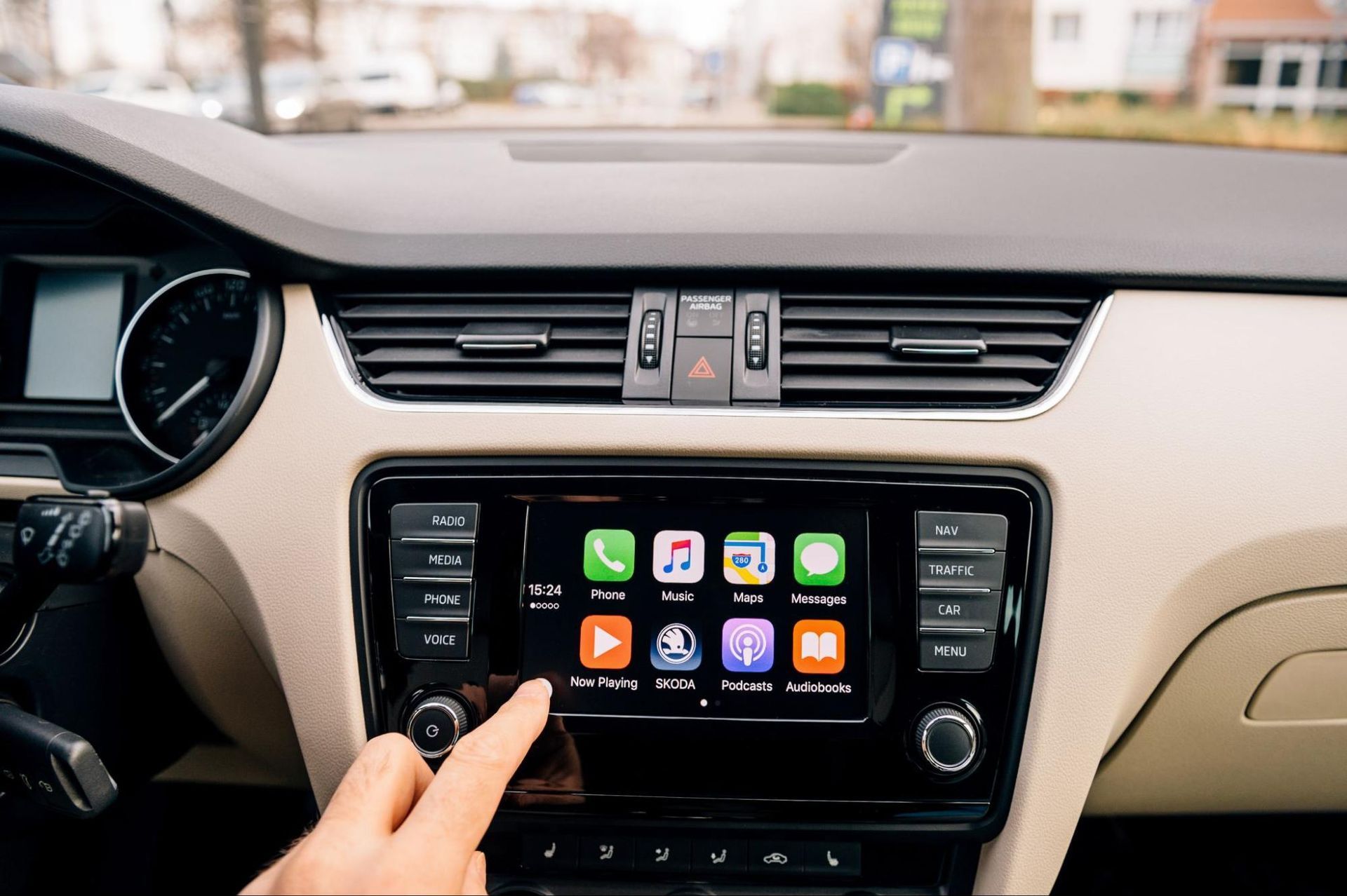 A person is pressing a button on a car radio.