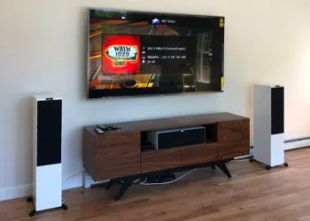 A living room with a flat screen tv and speakers