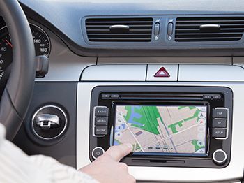 A person is using a navigation system in a car