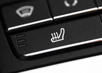 A close up of a heated seat button on a car dashboard.