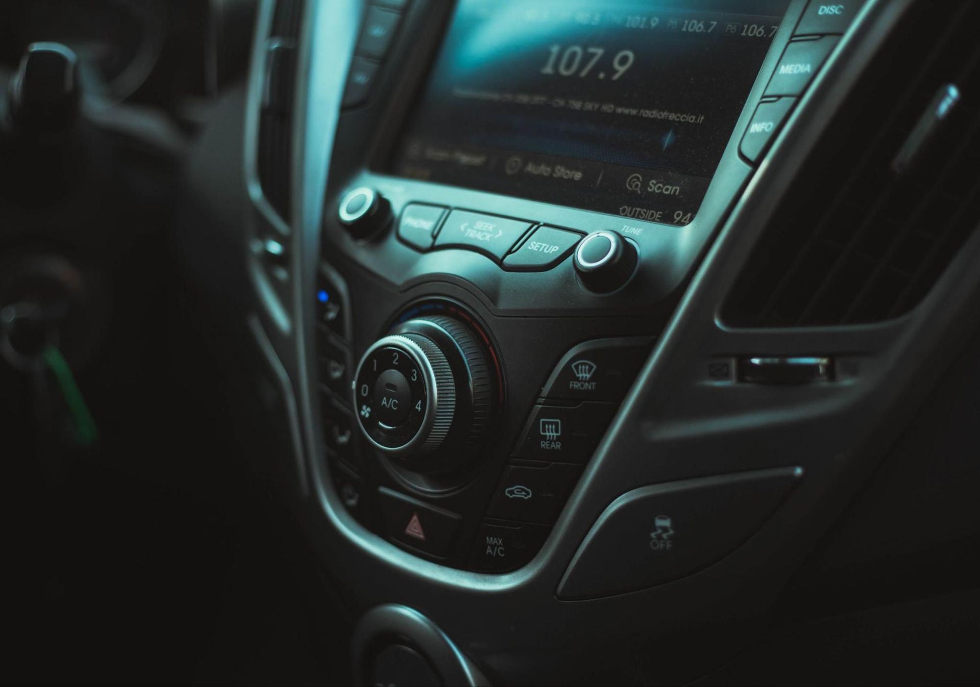 A close up of a car radio with 107.9 on the screen