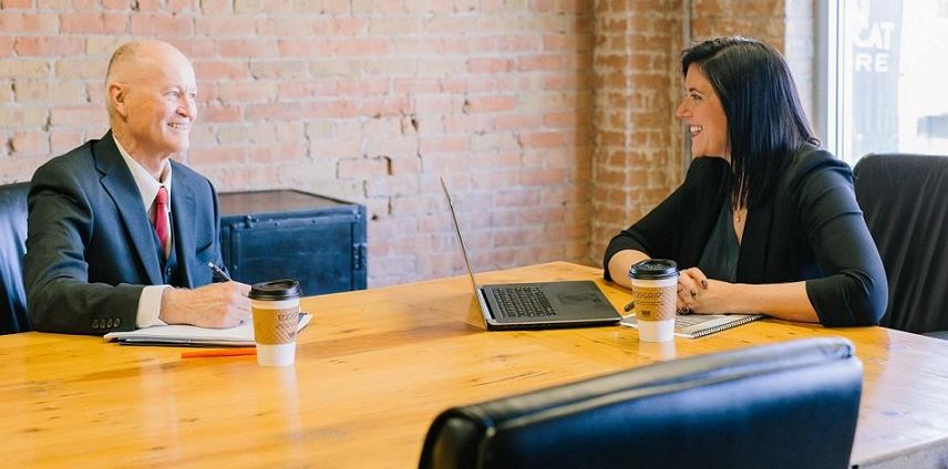 man and woman sitting at table for meeting