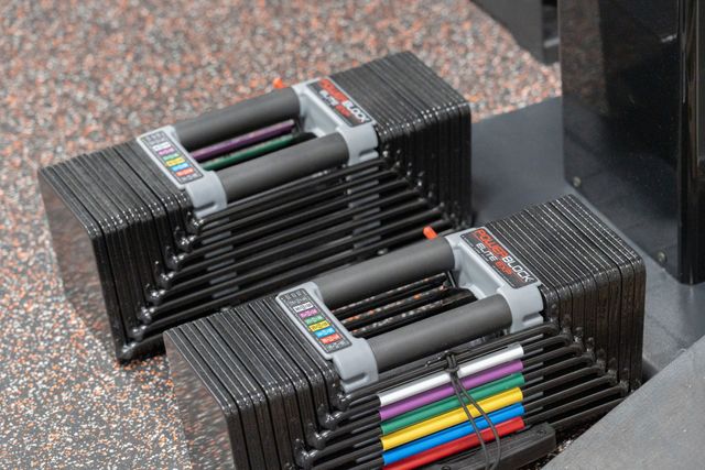 Stacks of colorful markers on a speckled countertop, arranged in neat rows.