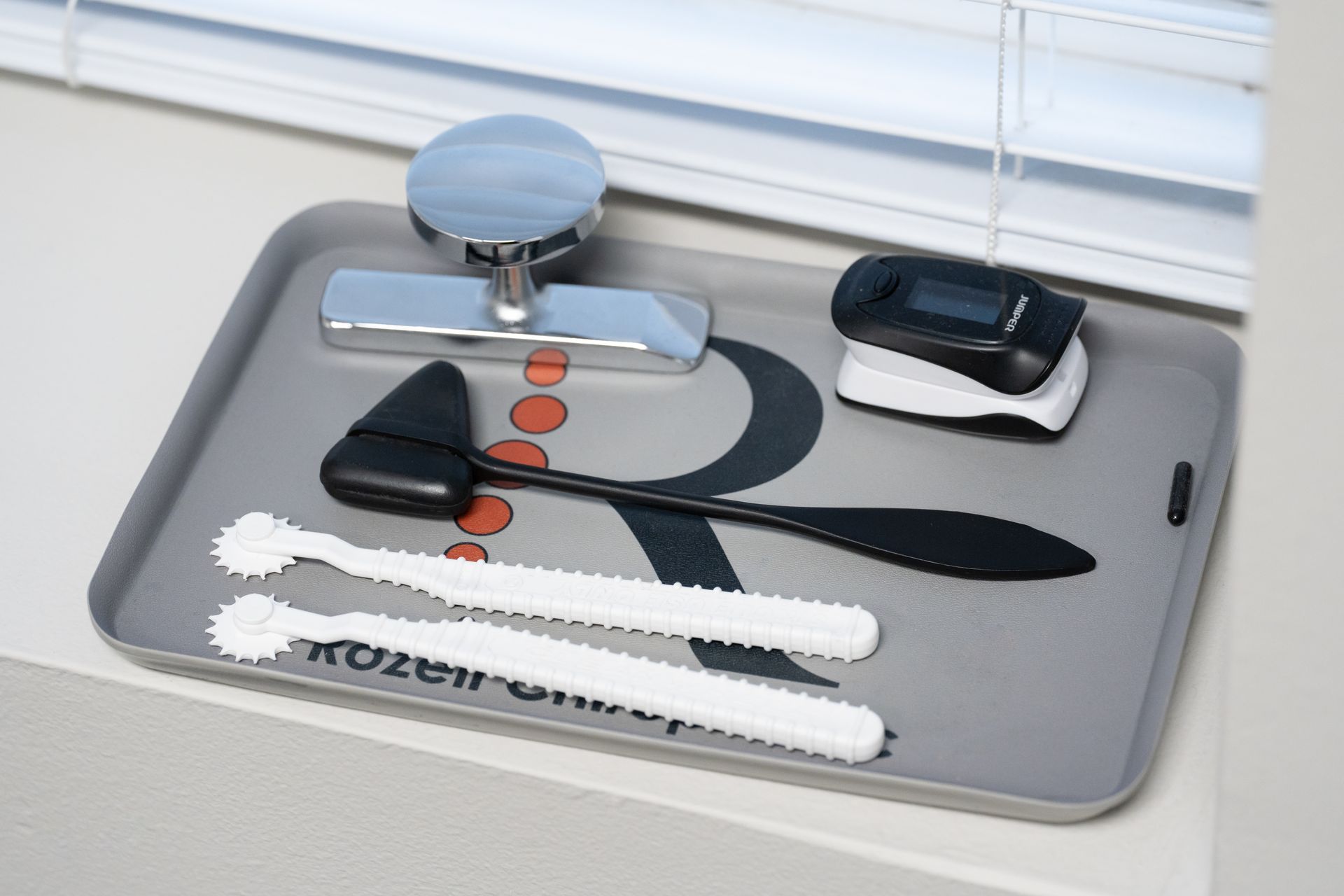 Tray with assorted grooming tools on a table by a window