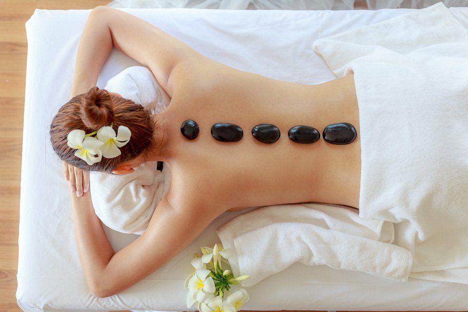 Woman Having Stone Massage | Roselle, IL | Velarde Salon & Spa